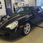 black sports car in detailing garage