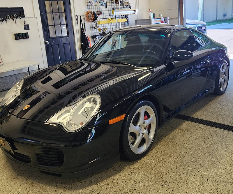 black sports car in detailing garage