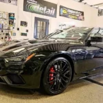 black sports car with shiny exterior in detail shop