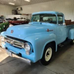 old-fashioned classic truck with light blue paint in detail garage